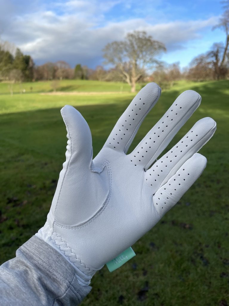 Mitt Golf glove being worn on the left-hand out on the golf course