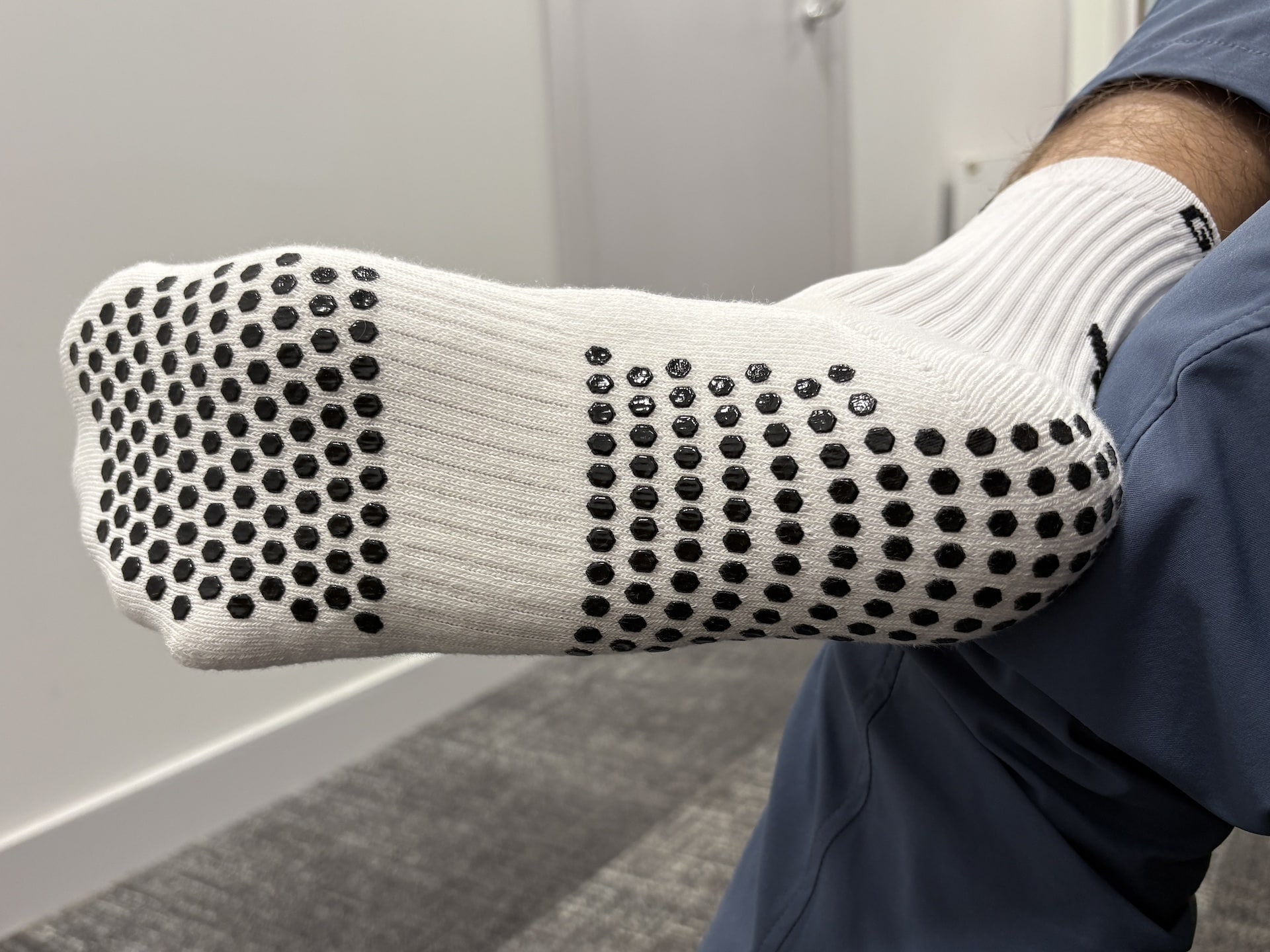 Underside of Torn golf socks with black spots