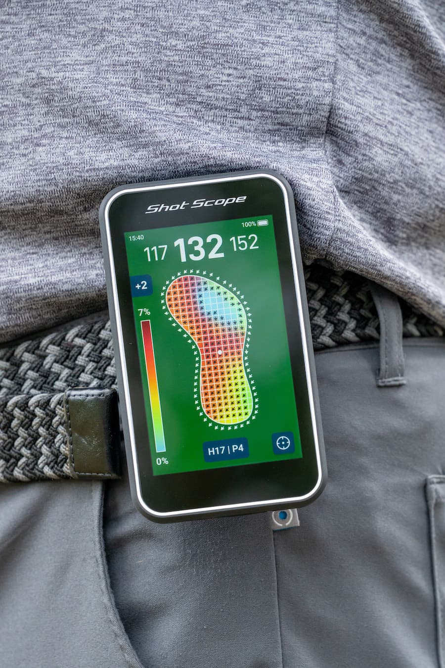 Shot Scope H50 Handheld on the golf course attached to golfer's belt