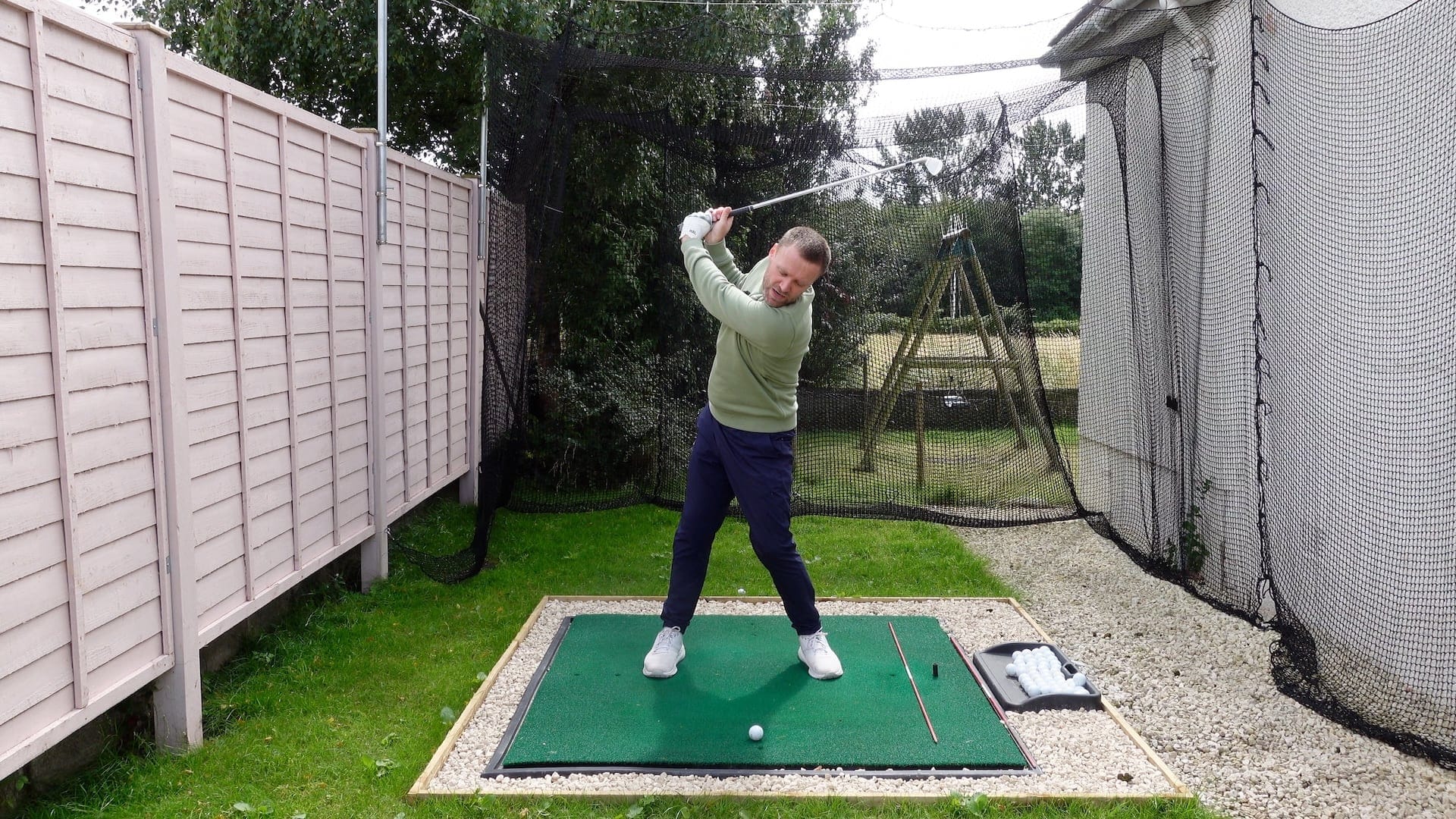 Golfer in reverse pivot position on backswing