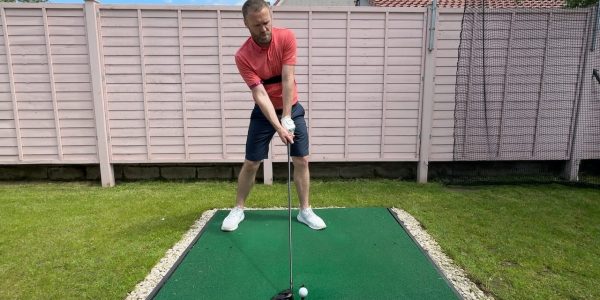 Andy setting up to hit a driver whilst wearing the TRS Slider swing training aid.